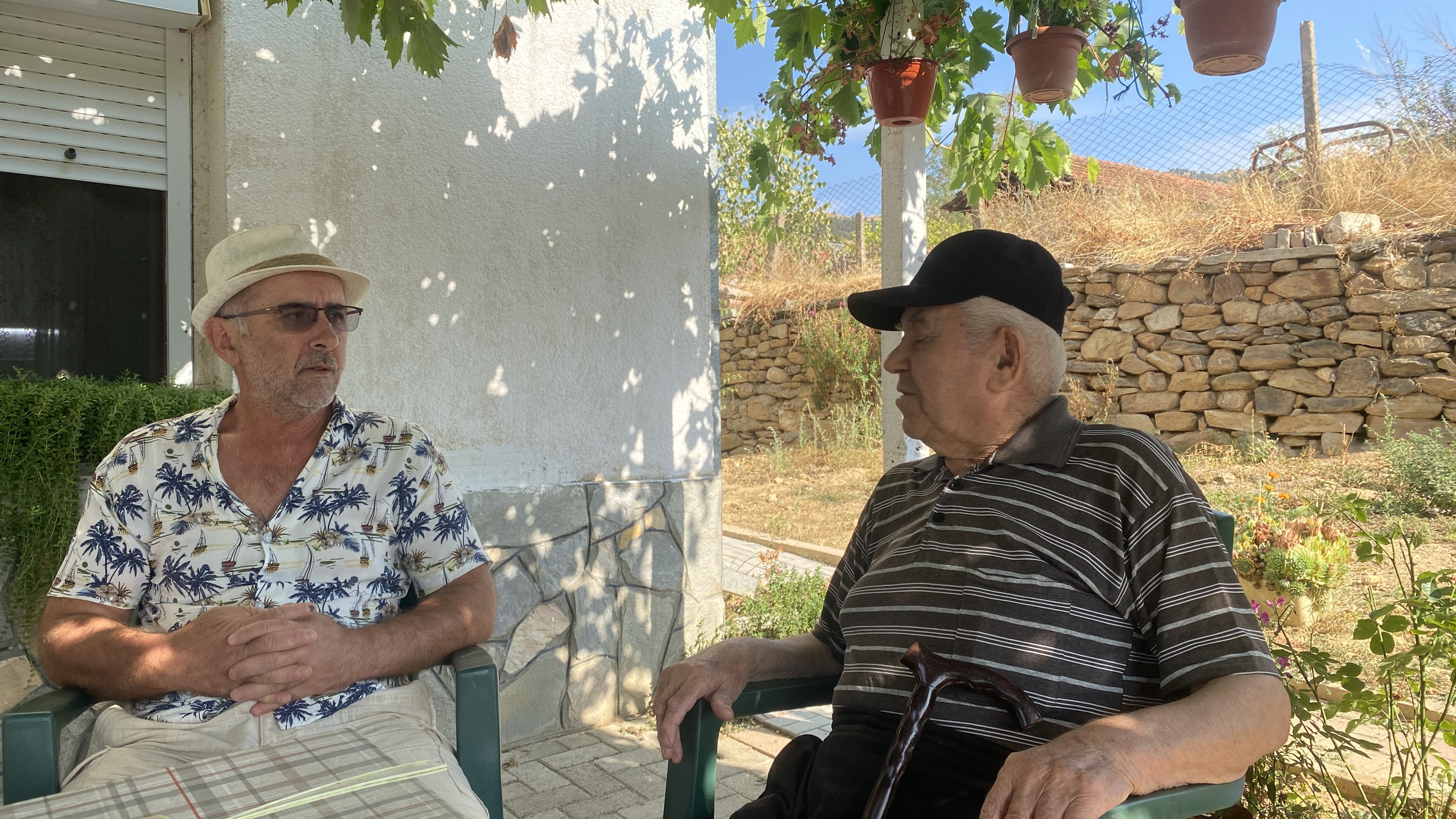 Uncle and nephew under grapevine in Macedonian village