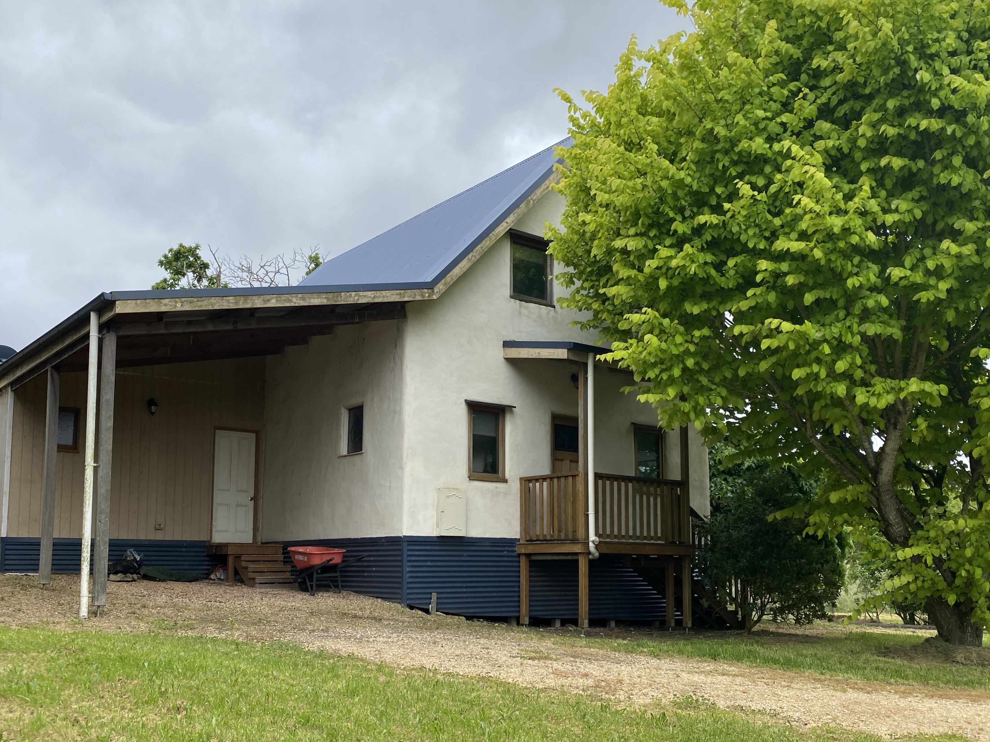 Rendered exterior of the completed Daylesford light-earth house in its garden setting