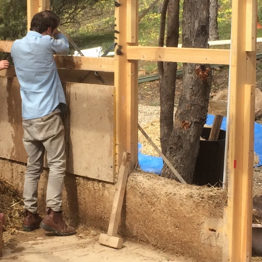 Straw-clay wall infill exposed below temporary shuttering during construction